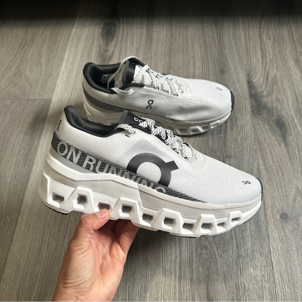 On Running White and Black Athletic Shoes with Air Cushioning